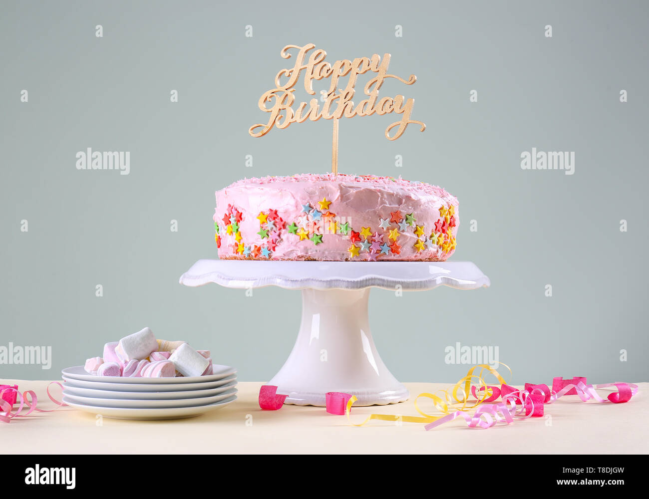 Stand with tasty birthday cake on table Stock Photo - Alamy