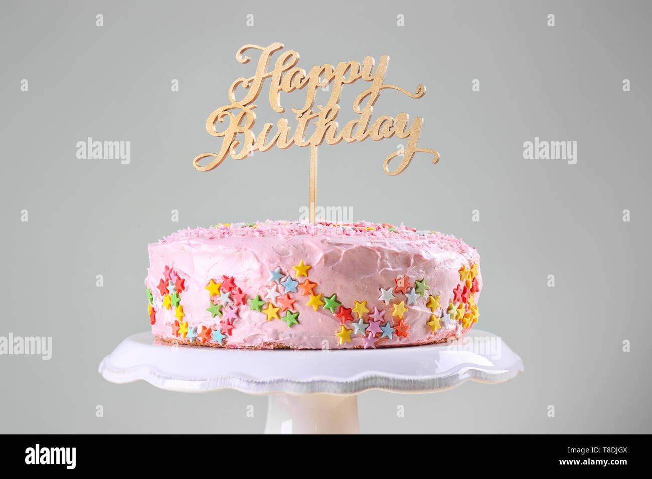 Stand with tasty birthday cake on light background Stock Photo - Alamy