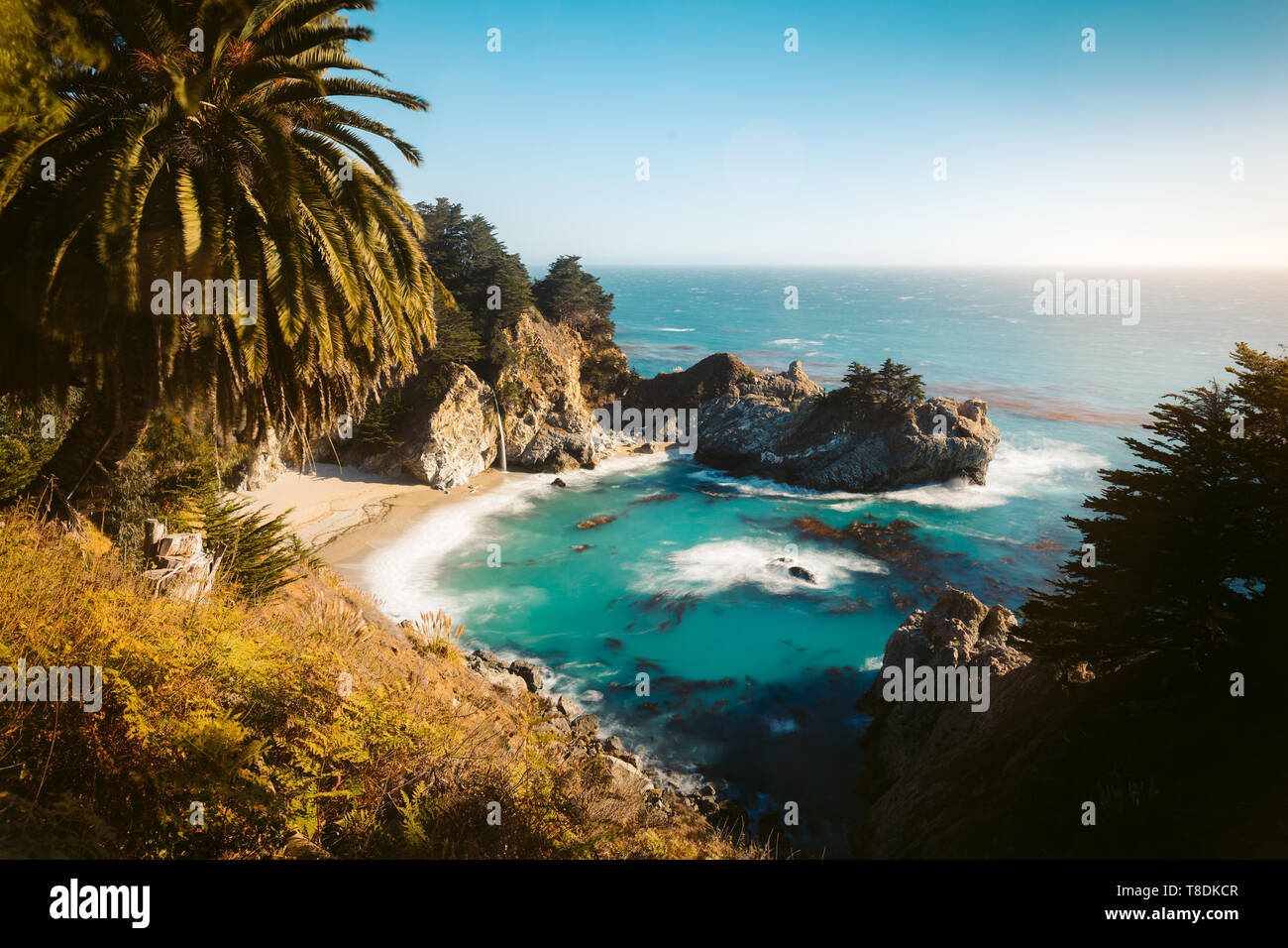 Famous McWay Falls in golden evening light at sunset on a beautiful sunny day with in summer, Julia Pfeiffer Burns Stae Park, Big Sur, California, USA Stock Photo