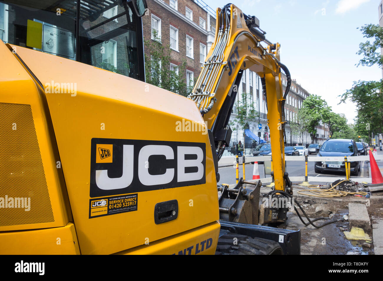 Roadworks and a JCB Digger on a street in London Stock Photo