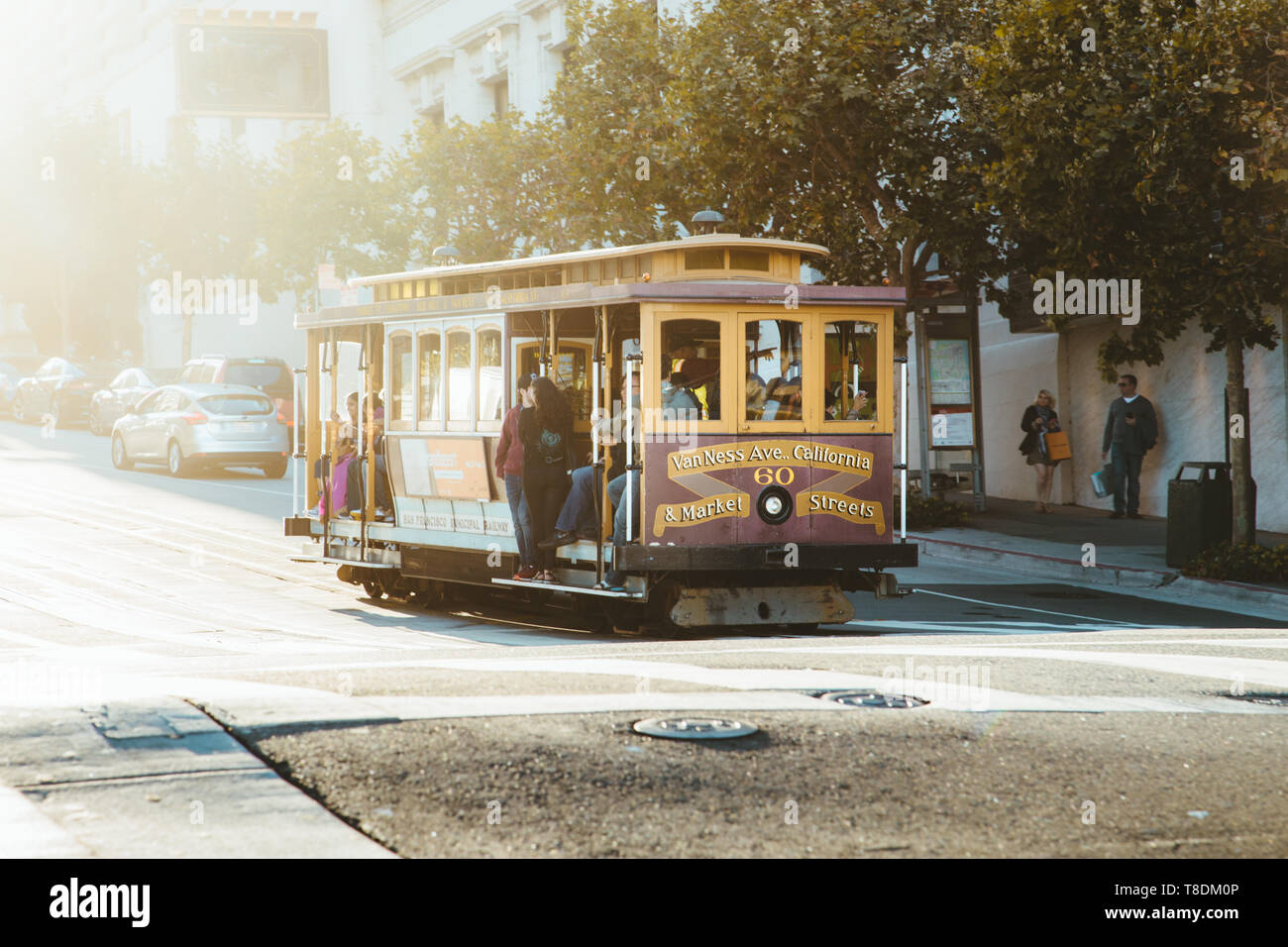 SAN FRANCISCO, USA - September 5, 2016: Historic Cable Cars riding on famous California Street in beautiful golden evening light at sunset, San Franci Stock Photo