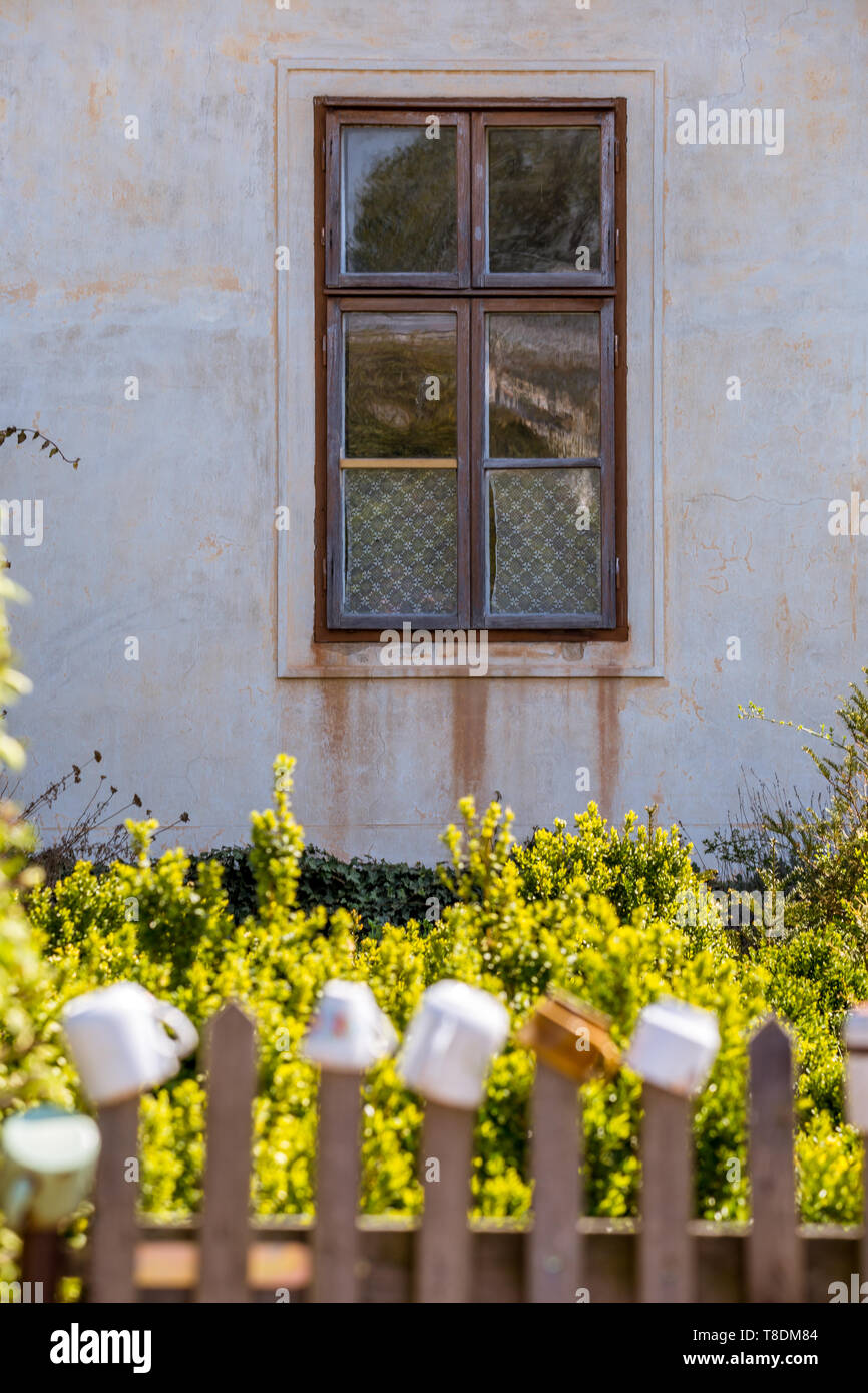 Old farm building and dwelling house, climbing roses and flowers, picturesque windows and doors it is a romantic corner near Milotice Castle, South Mo Stock Photo