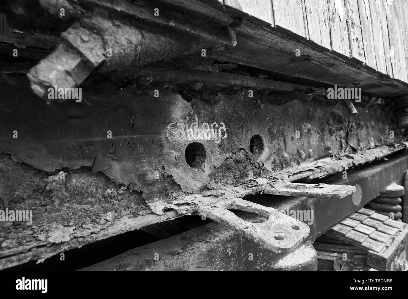 Detail of boiler intake in rusty train car at the abandoned Canfranc International railway station (Canfranc, Pyrenees, Huesca, Aragon,Spain) B&W vers Stock Photo