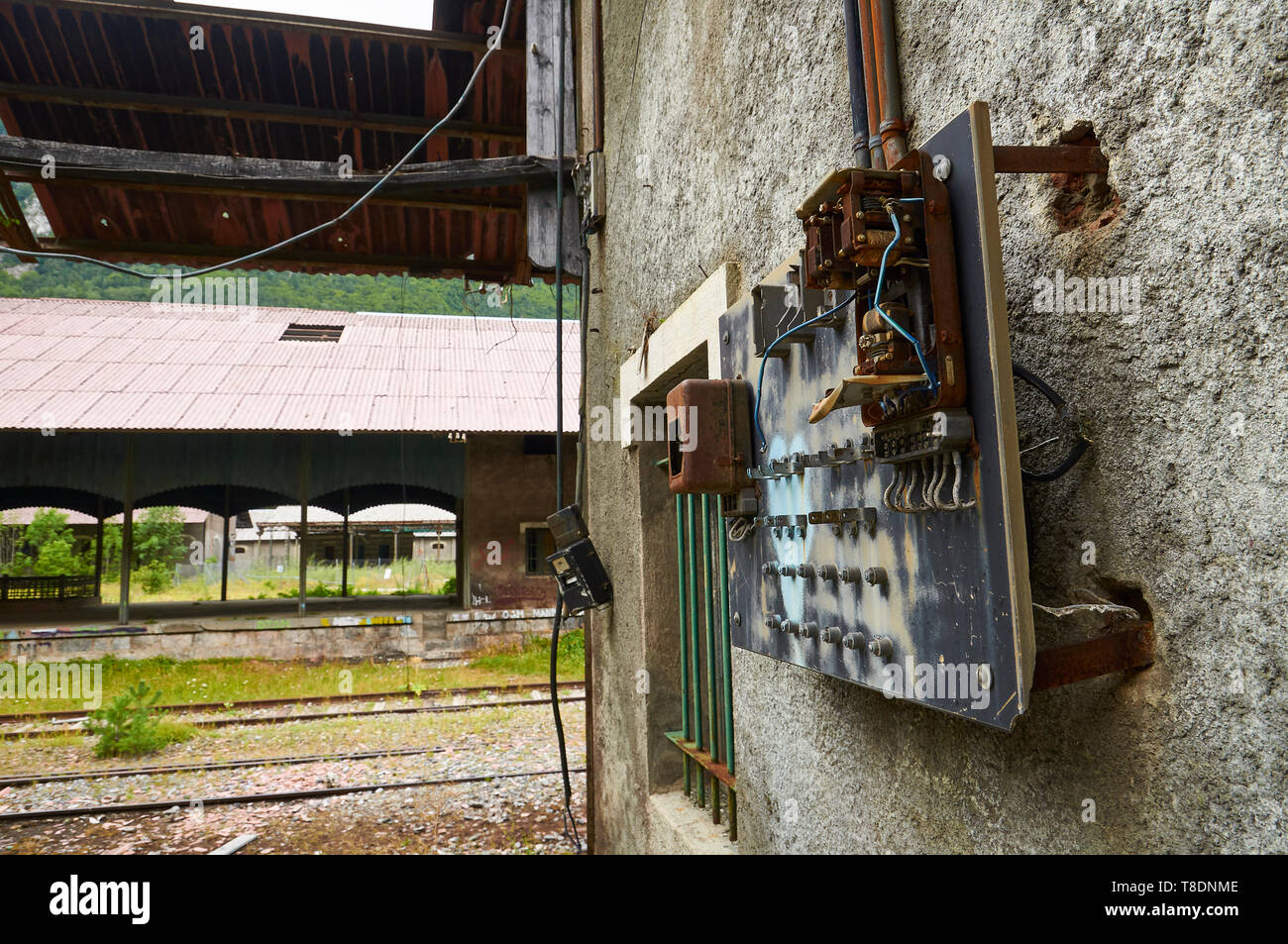 Rusty old distribution panel and electric meter at the abandoned Canfranc International railway station (Canfranc, Pyrenees, Huesca, Aragon, Spain) Stock Photo
