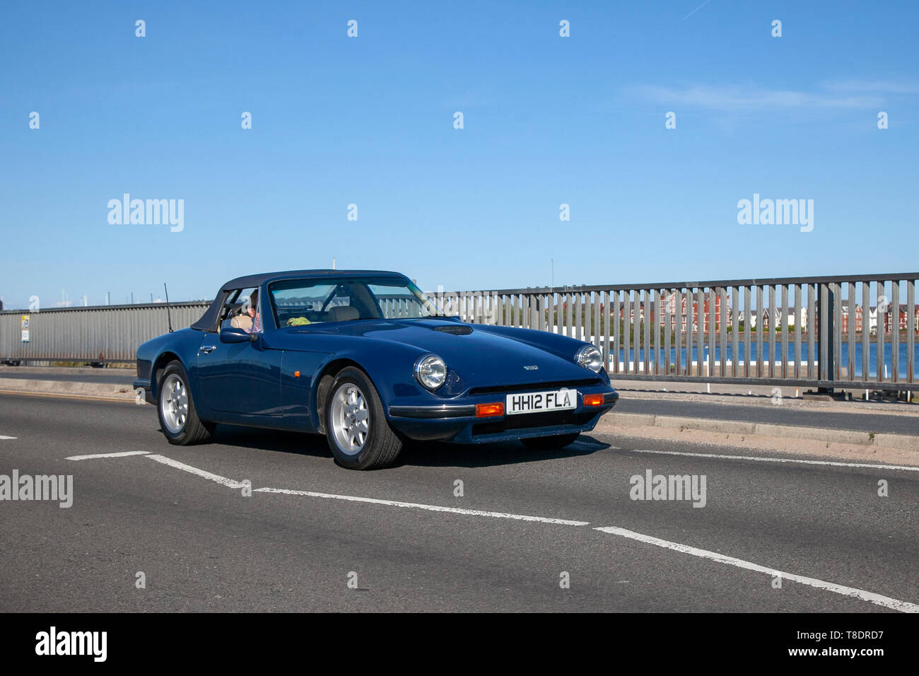 1990 blue Tvr 290 S being driven on Southport seafront promenade, UK Stock Photo