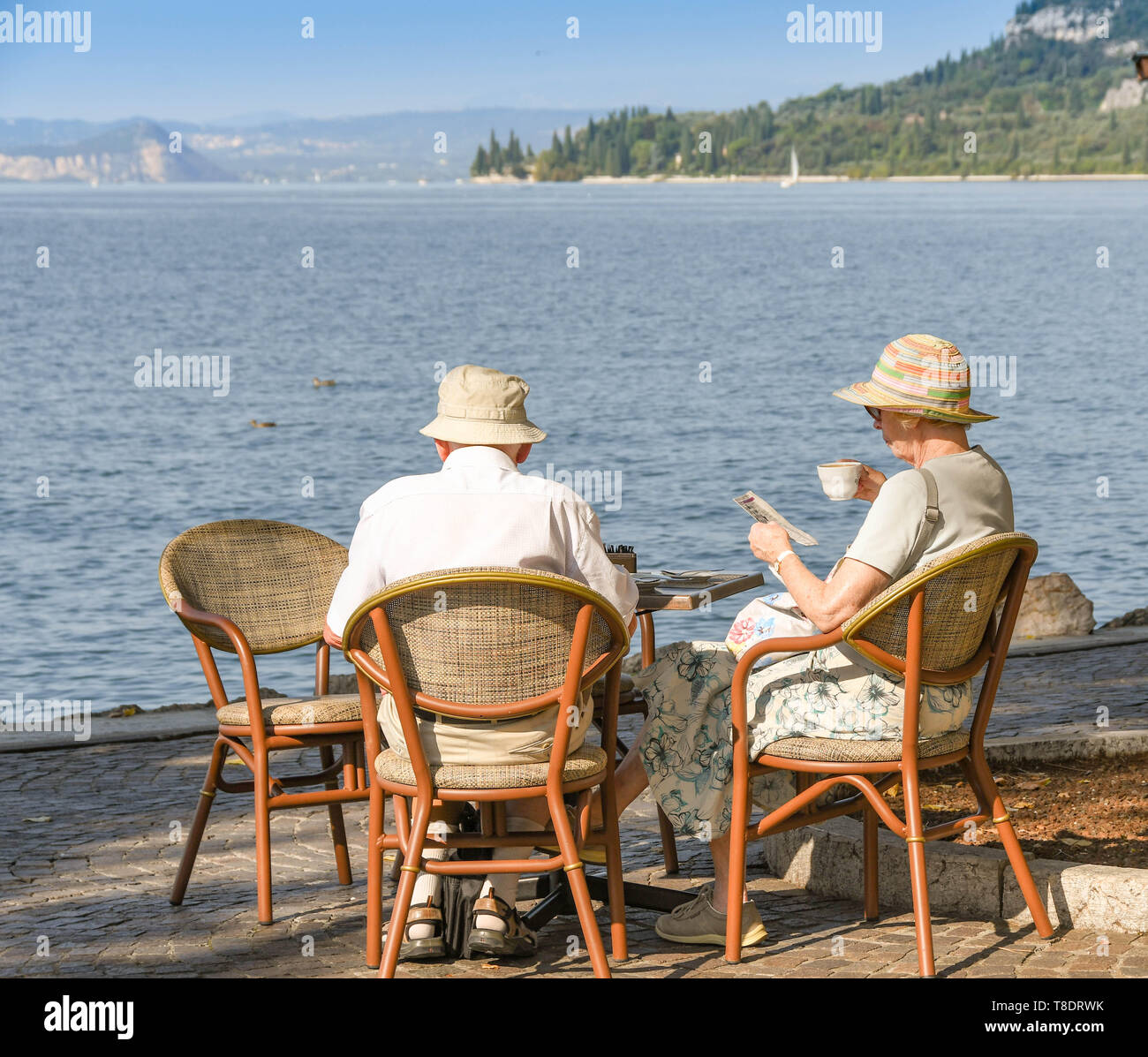 Man sitting on lake garda waterfront hi-res stock photography and ...