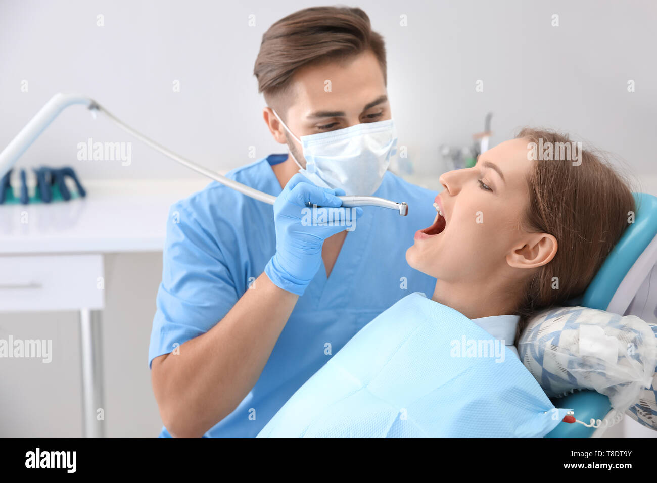 Dentist filling patient's teeth in clinic Stock Photo Alamy