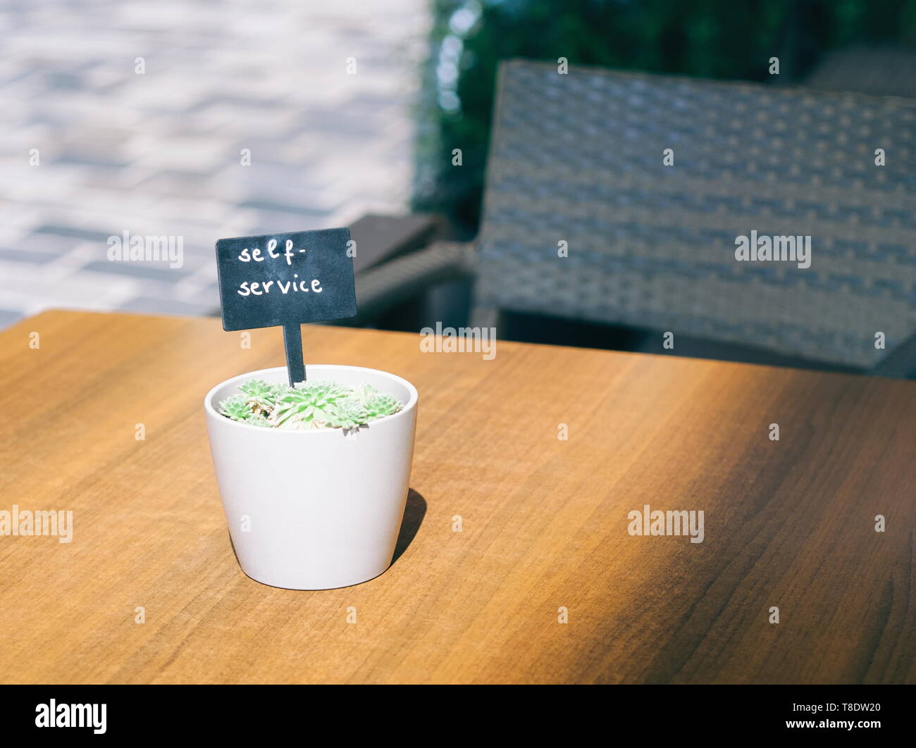 Self Service Sign on Wooden Table Outdoors Stock Photo
