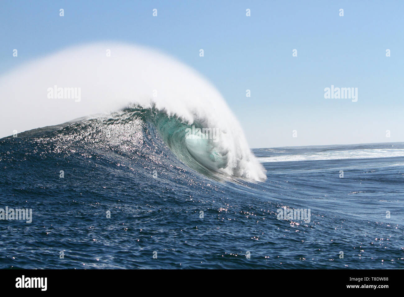 A big, perfect wave at Dungeons off Hout Bay in South Africa. Sunny, offshore days are rare. Stock Photo