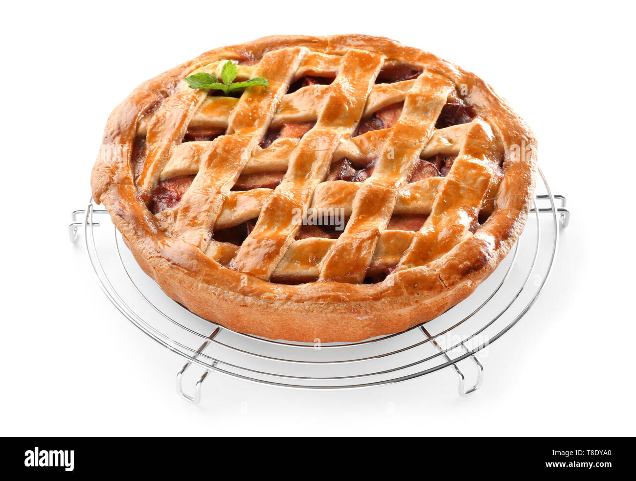 Cooling rack with delicious peach pie on white background Stock Photo ...