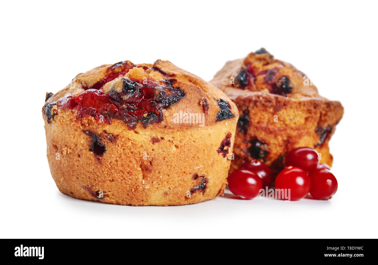Sweet tasty muffins with cranberry on white background Stock Photo
