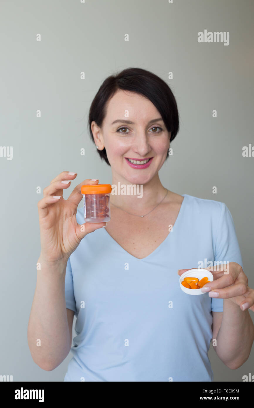 Young doctor holding pill container hi-res stock photography and images ...