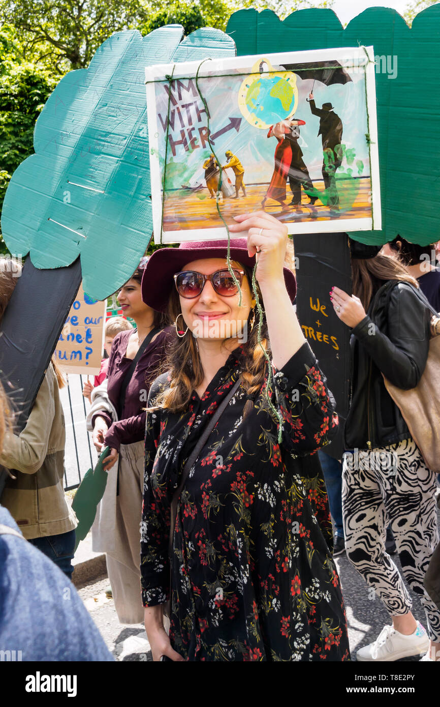 London, UK. 12th May 2019. A woman holds up a poster on the XR International Mothers Day March by several thousand mothers, children and some fathers from Hyde Park Corner to a rally filling Parliament Square, backing Extinction Rebellion's call for the drastic and urgent action needed to avert the worst consequences of climate change, including possible human extinction. Our politicians have declared a climate emergency but now need to take real action rather than continuing business as usual which is destroying life on our planet. Peter Marshall/Alamy Live News Stock Photo