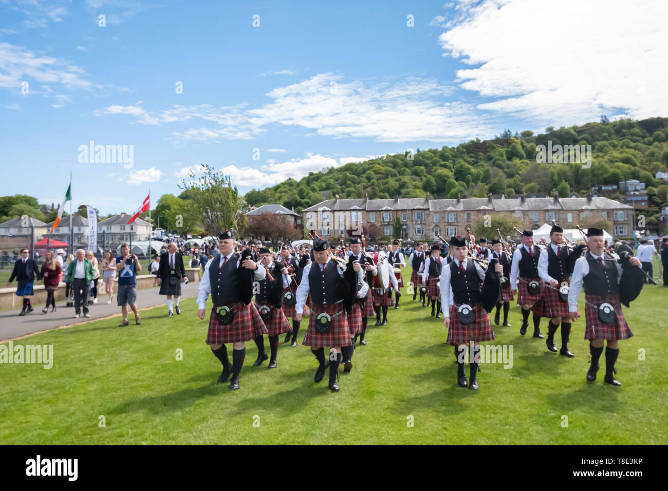 Greenock, Scotland, UK. 12th May, 2019. A pipe band enters the competition arena at the 63rd annual Gourock Highland Games which celebrates traditional Scottish culture with pipe band competitions, highland dancing, traditional highland games and is held in the picturesque setting of Battery Park.  Credit: Skully/Alamy Live News Stock Photo