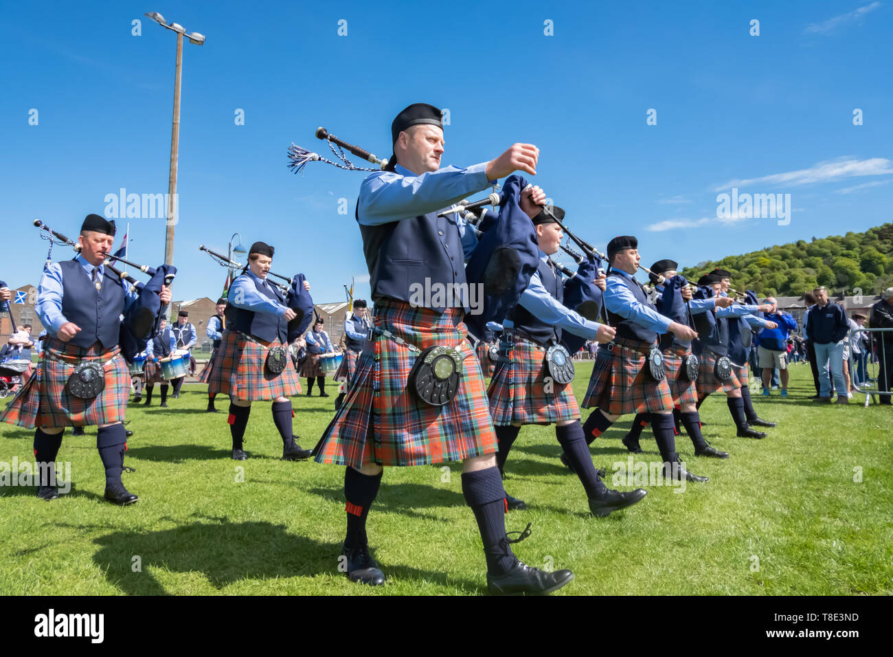 Greenock, Scotland, UK. 12th May, 2019. A pipe band enters the competition arena at the 63rd annual Gourock Highland Games which celebrates traditional Scottish culture with pipe band competitions, highland dancing, traditional highland games and is held in the picturesque setting of Battery Park.  Credit: Skully/Alamy Live News Stock Photo