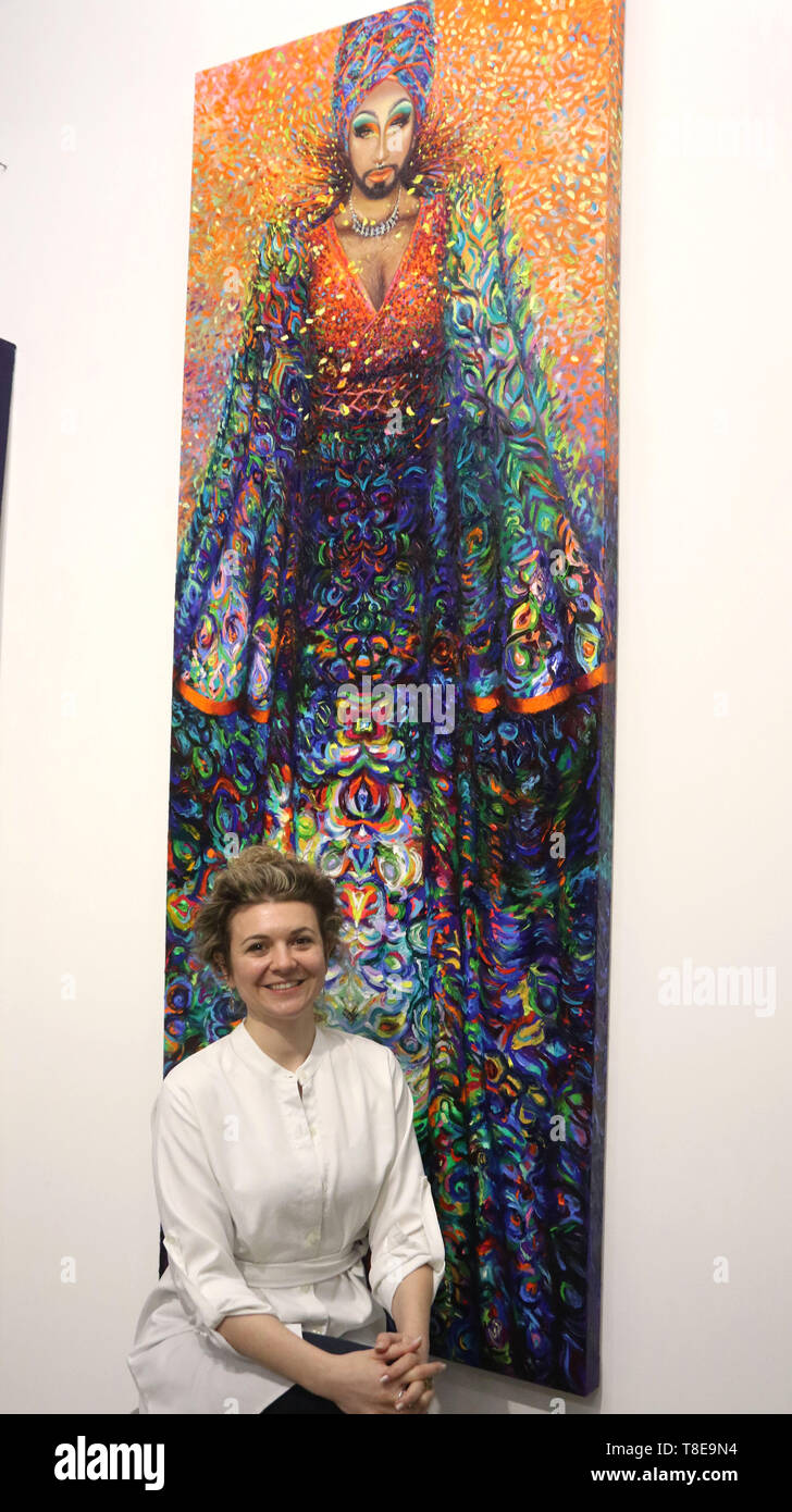 New York City, New York, USA. 12th May, 2019. Artist IRIS SCOTT, the  world's first-ever full time professional finger-painter poses in front of  one of her 11 foot paintings during her art