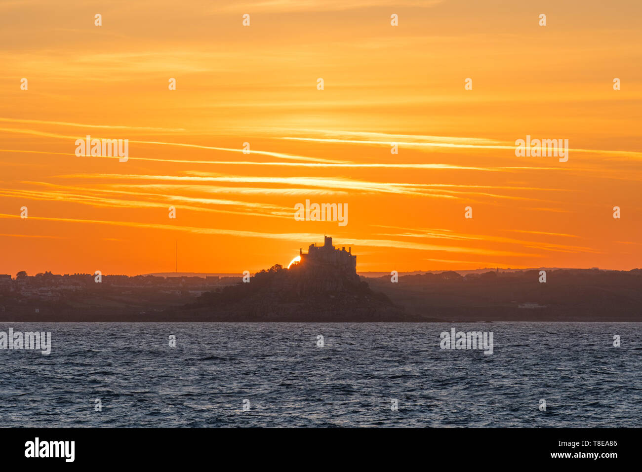Newlyn, Cornwall, UK. 13th May 2019. A fresh breeze and another glorious sunrise over St Michaels Mount this morning. Credit Simon Maycock / Alamy Live News. Stock Photo