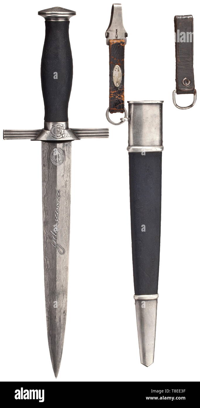 An honour dagger with Damascus blade for RLB leaders Damascus blade with reverse motto 'Treue Kameradschaft' in raised etching, obverse maker's logo of Weyersberg, Solingen and name in raised etching. Nickel silver grip fittings, the pommel with etched oak leaves, the cross-guard with an RLB national eagle in relief, the reverse with an etched owner's monogram 'CE' framed by oak leaves. Blue leathered grip with filigreed RLB emblem (minimal enamel chip). The blue leather-covered steel scabbard with silver-plated fittings, the front with an etched oak leaf décor. Short blue , Editorial-Use-Only Stock Photo