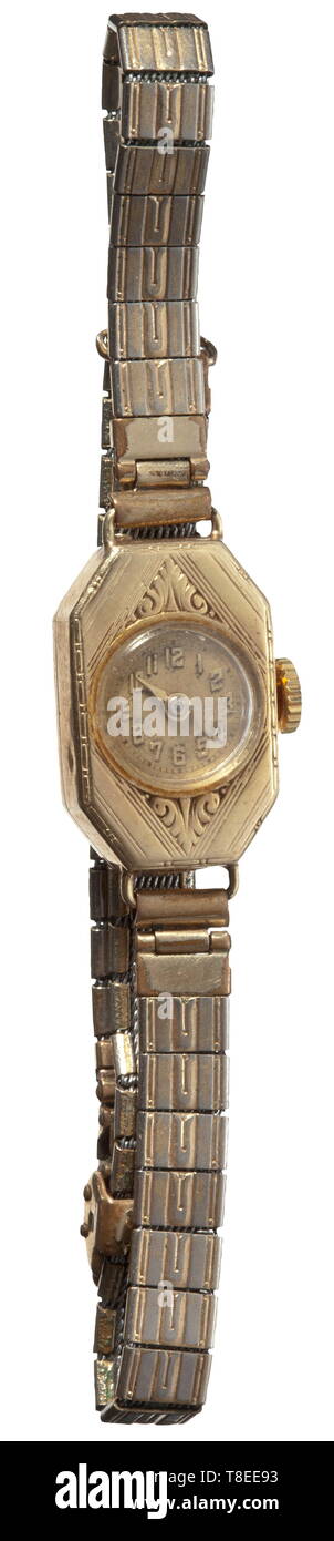 Eva Braun (1912 - 1945) - a golden lady's wrist watch Slender rectangular gold casing with slanted edges and engraved leaf pattern, gilt silver watch band links, stamp for gold of 14 carat, barely legible jeweller's stamp, the casing 20 x 18 mm. In a case of the Munich watch and chronometer maker Karl Schmutzer. Provenance: Ilse Fucke-Michels, Eva Braun's sister. According to her written confirmation (enclosed in copy) this wrist watch was an early gift of Hitler's to Eva Braun after a joint visit to the theatre. historic, historical, 20th century, 1930s, NS, National Socia, Editorial-Use-Only Stock Photo