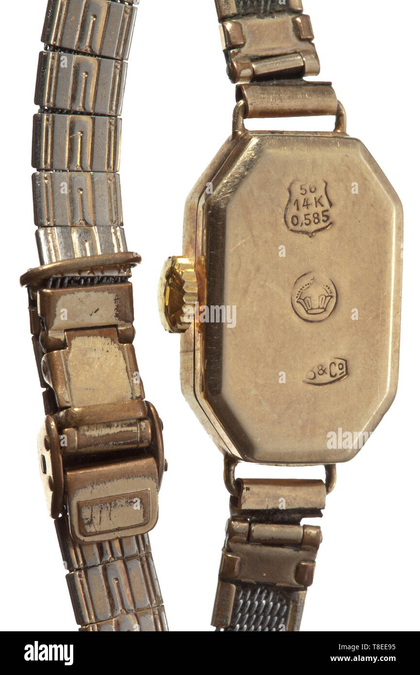 Eva Braun (1912 - 1945) - a golden lady's wrist watch Slender rectangular gold casing with slanted edges and engraved leaf pattern, gilt silver watch band links, stamp for gold of 14 carat, barely legible jeweller's stamp, the casing 20 x 18 mm. In a case of the Munich watch and chronometer maker Karl Schmutzer. Provenance: Ilse Fucke-Michels, Eva Braun's sister. According to her written confirmation (enclosed in copy) this wrist watch was an early gift of Hitler's to Eva Braun after a joint visit to the theatre. historic, historical, 20th century, 1930s, NS, National Socia, Editorial-Use-Only Stock Photo