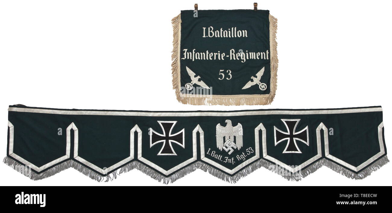A kettle-drum banner and a trumpet banner of 1st Battalion, Infantry Regiment 53 The kettle-drum hanging of fine, dark green cloth with silver braided edges terminating in silver fringes. The centre with an army eagle in raised silver embroidery above an unit designation 'I.Batl. Inf.Rgt. 53' embroidered en suite, flanked by two Iron Crosses of black cloth with silver embroidered frames. Reverse black linen liner with leather strap as well as leather closure strap. Dimensions ca. 195 x 35 cm. In very beautiful condition. The trumpet banner of dar, Additional-Rights-Clearance-Info-Not-Available Stock Photo