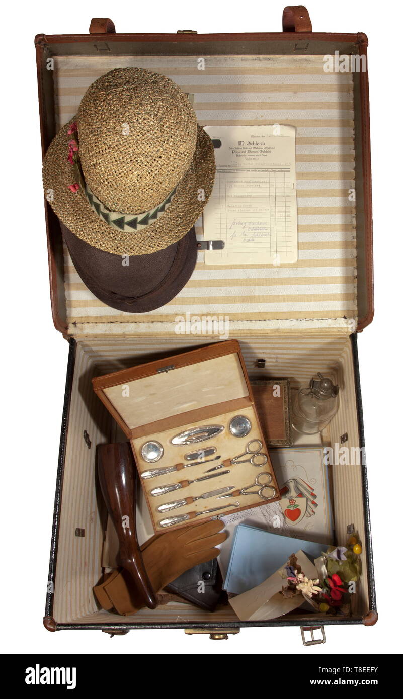 Angela 'Geli' Maria Raubal (1908 - 1931) - a large hat box with comprehensive contents Black hat box with brown leather trim, the interior lined with a striped fabric. Two woven summer hats, one with a small bouquet, in the lid the invoice of the flowers and accessoires shop M. Schleich, Munich, for refurbishing two summer hats for Angela Raubal, Prinzregentenplatz 16/2 from 6 May 1930. An envelope with a flower decoration for a dirndl, receipt of the ladies´ fashion store Spicker from 10 July 1931 and further flowers, large pigskin case with 10 silver-plated manicure instr, Editorial-Use-Only Stock Photo