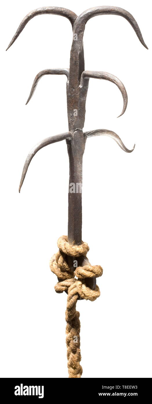 A rare military grappling hook 17th/18th century. Of wrought iron, the head  formed with three pairs of hooks in an off-set arrangement, and with  suspension ring carrying a length of early rope.