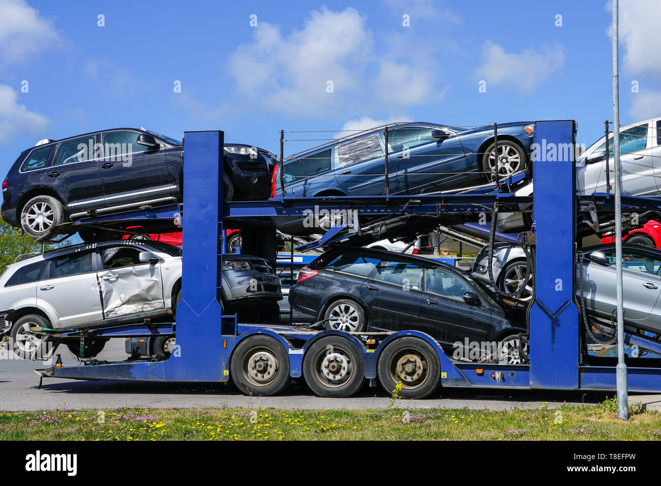 Car carrier trailer with used cars for sale on bunk platform Stock