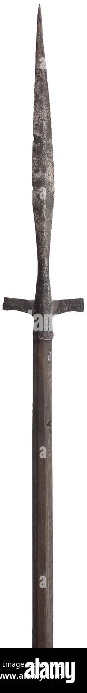 An early Medieval lugged spear post-Frankish culture, 9th-10th century. In excavated condition, the head with long slender leaf-shaped blade of flattened diamond section tapering to a long narrow point, the latter changing to Jack-diamond section, with traces of incised ornament at the base, tubular socket fitted with a pair of flat very slightly up-turned lugs or wings with concave lower edges, each incised with three vertical bands of four lines on both sides, and the socket incised with further linear ornament involving three incised chevron c, Additional-Rights-Clearance-Info-Not-Available Stock Photo