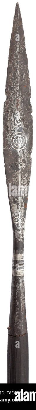 An early Medieval military spear inlaid with niello 8th-9th century. In excavated condition, the head with slender leaf-shaped blade of flattened diamond section, both sides inlaid centrally with three concentric niello rings enclosing a single pellet, a similar inlaid pattern above, of two rings, a pair of small single rings at the base, and faceted socket inlaid with a pattern of three close-set niello linear bands about the neck. On modern wooden haft. Head 41.4 cm. Overall length 223 cm. historic, historical, weapons, arms, weapon, arm, baron, Additional-Rights-Clearance-Info-Not-Available Stock Photo