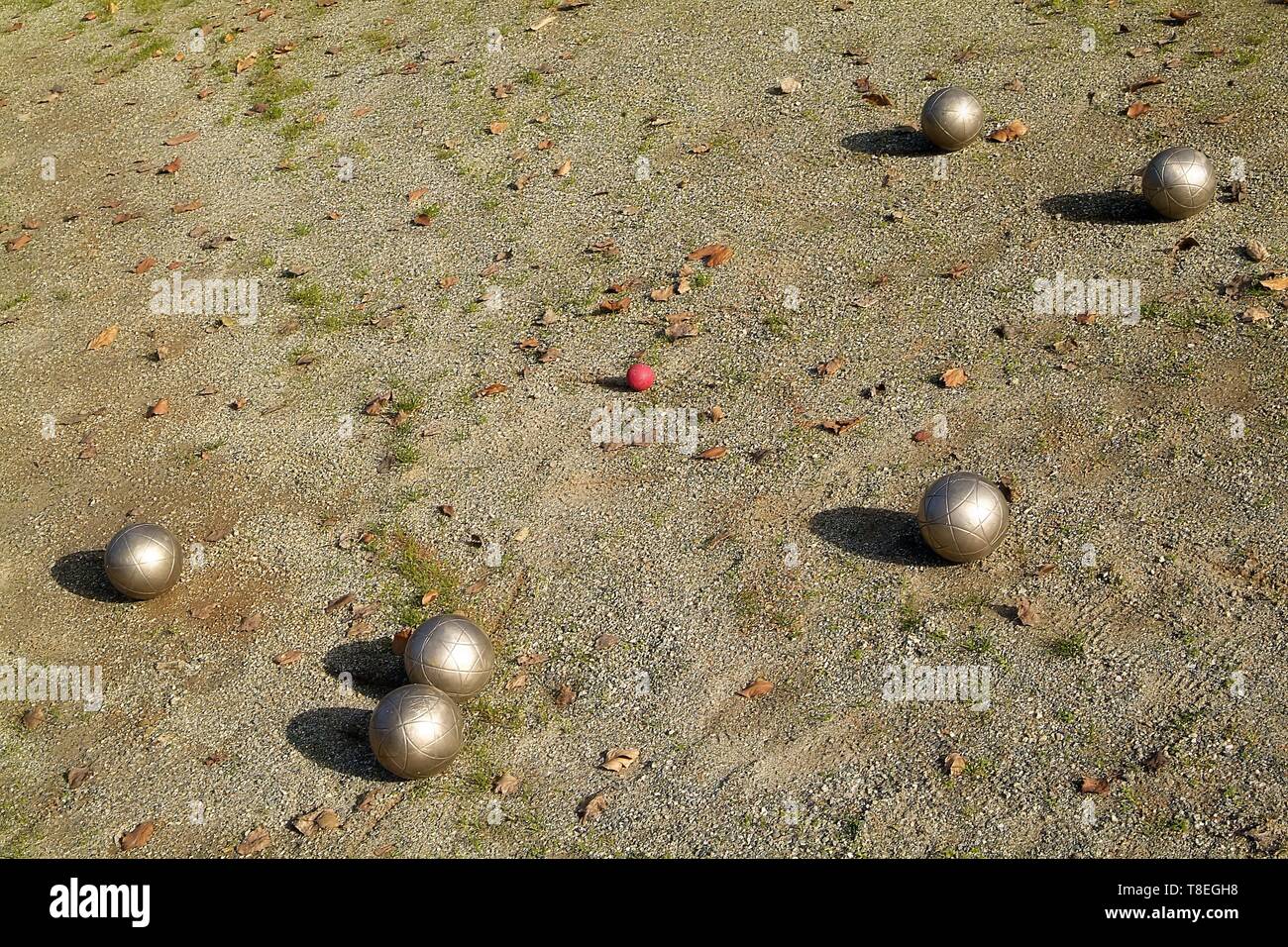 Four Boccie balls on the dike of in italy in front of blue North sky Stock Photo