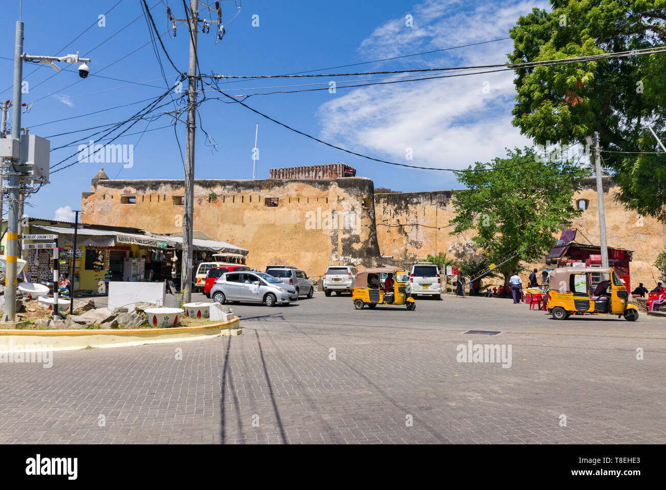 Exterior of Fort Jesus with vehicles, tuk tuks and people outside, Mombasa, Kenya Stock Photo