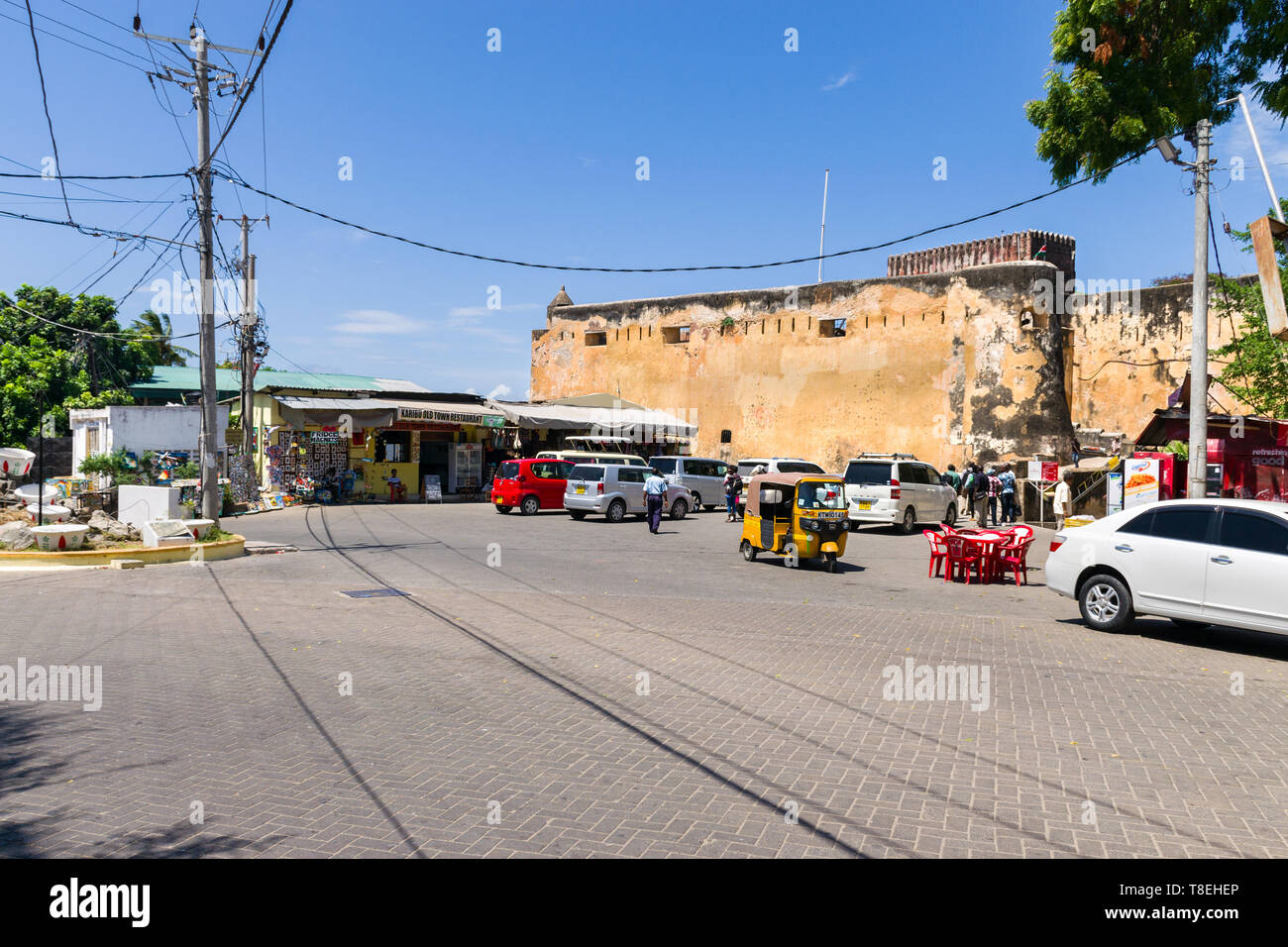 Exterior of Fort Jesus with vehicles, tuk tuks and people outside, Mombasa, Kenya Stock Photo