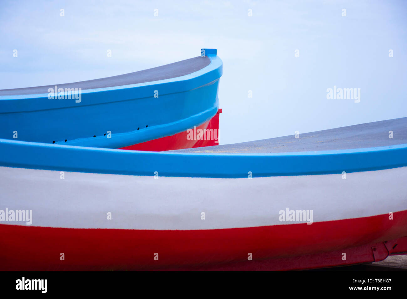 background of fishing boats with blue sky. Stern and bow of boats. Boats for summer. Boarding for vacations. Boats Bow Stock Photo