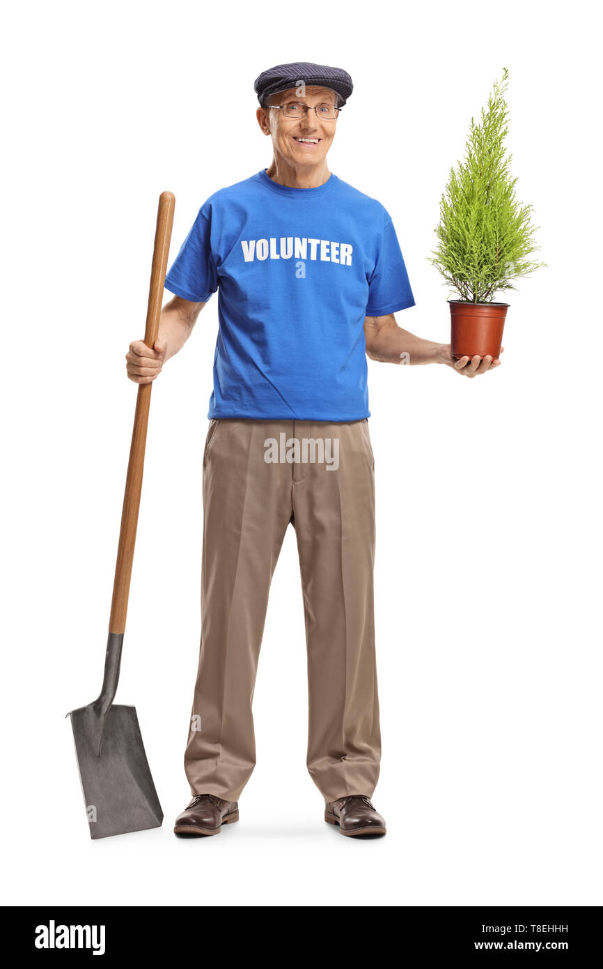 Full length portrait of a senior volunteer holding a plant and a shovel isolated on white background Stock Photo