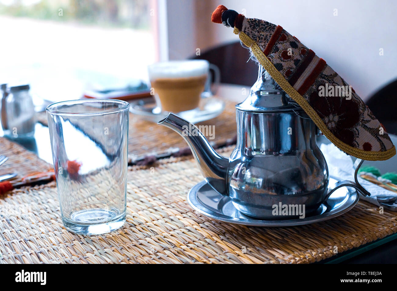 Moroccan tea with mint and sugar in a glasses on a copper plate with