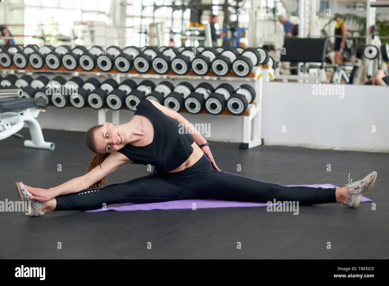Beautiful young flexible fitness woman doing splits during her workout  Stock Photo - Alamy