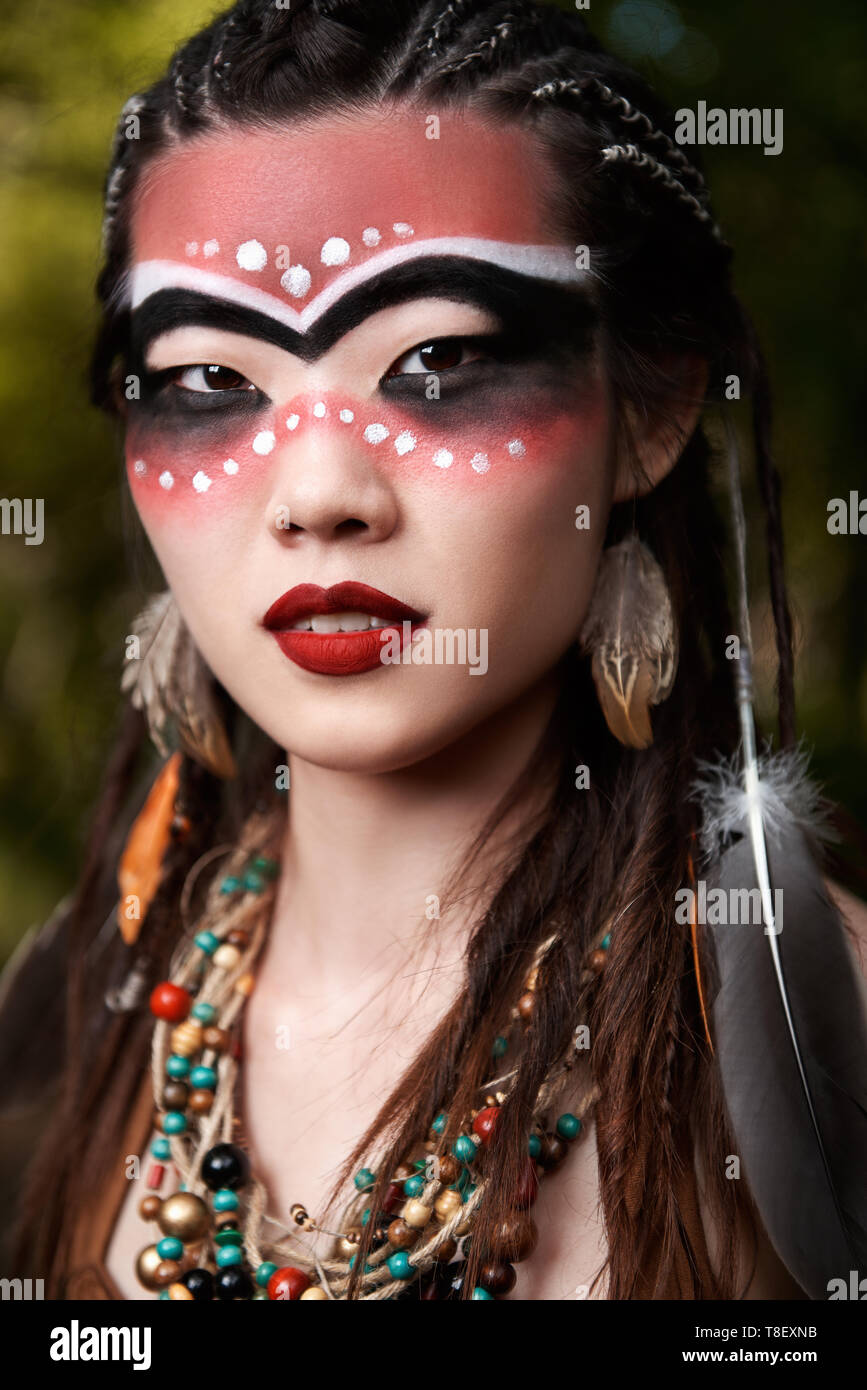 Outdoor close-up portrait of the pretty young shamaness (witch doctor) Stock Photo