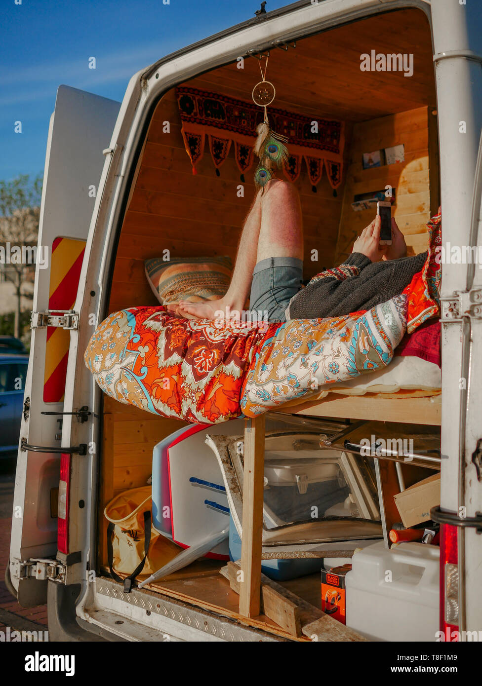 Alternative living in the City - A man sits in his converted home van in the centre of Cardiff Bay Stock Photo