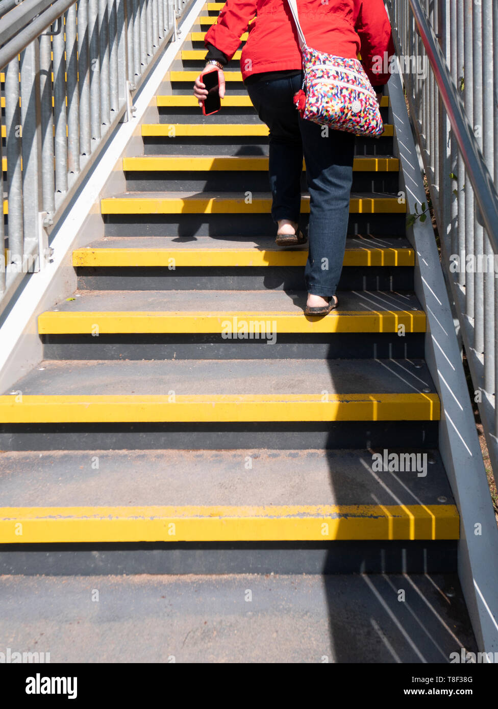 Elderly woman climbing stairs Stock Photo Alamy