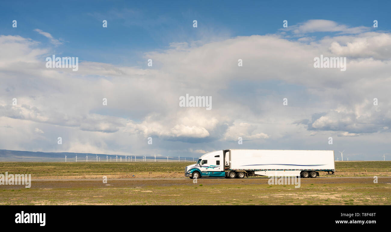 White big rig semi truck with cargo trailer on a Utah Highway Stock Photo