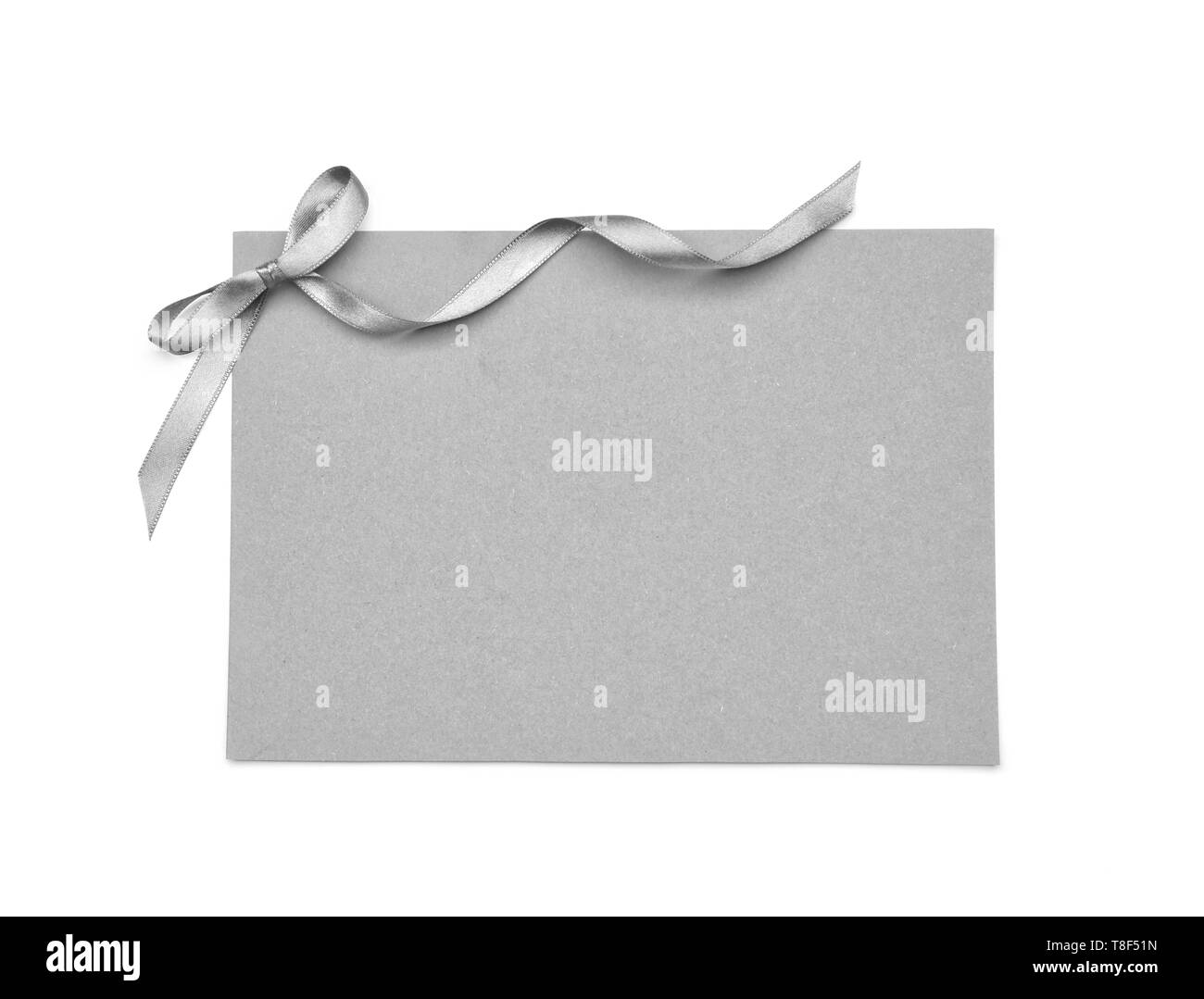 Blank paper card with silver ribbon and bow on white background Stock