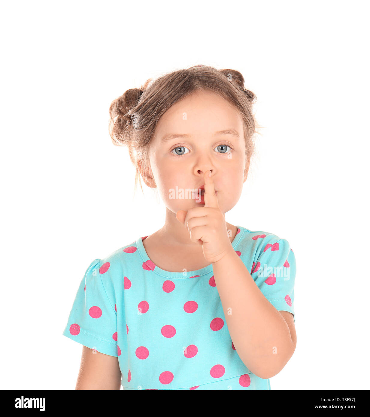 little girl showing Cute little girl showing silence gesture on white background Stock Photo -  Alamy
