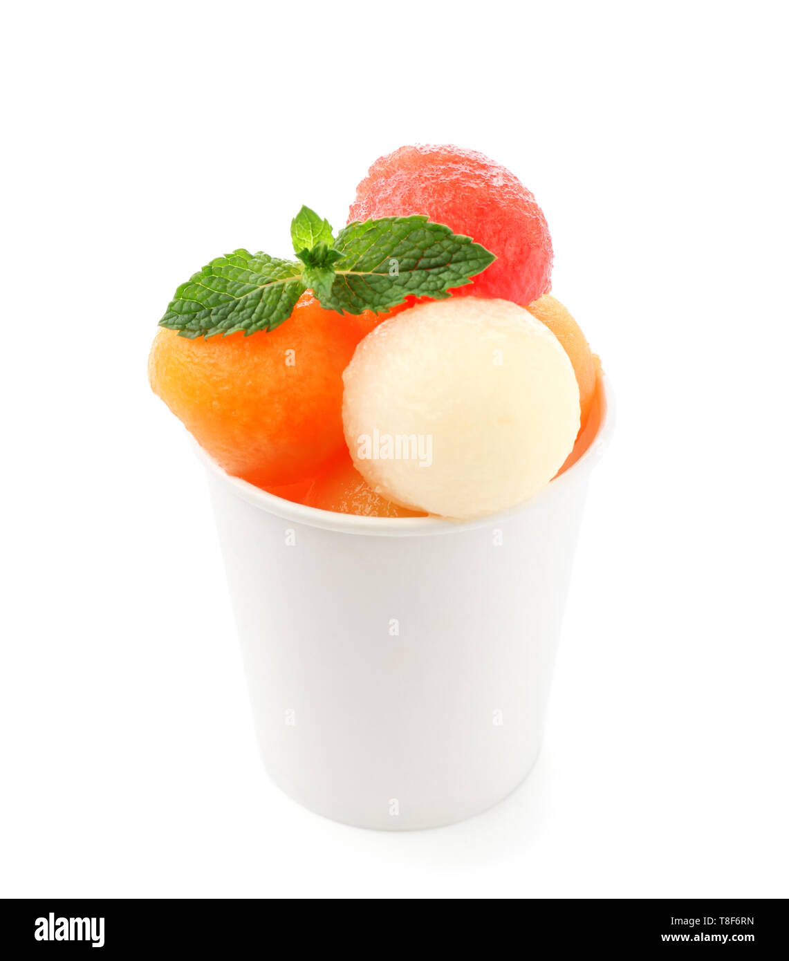Cup with fresh melon and watermelon balls on white background Stock