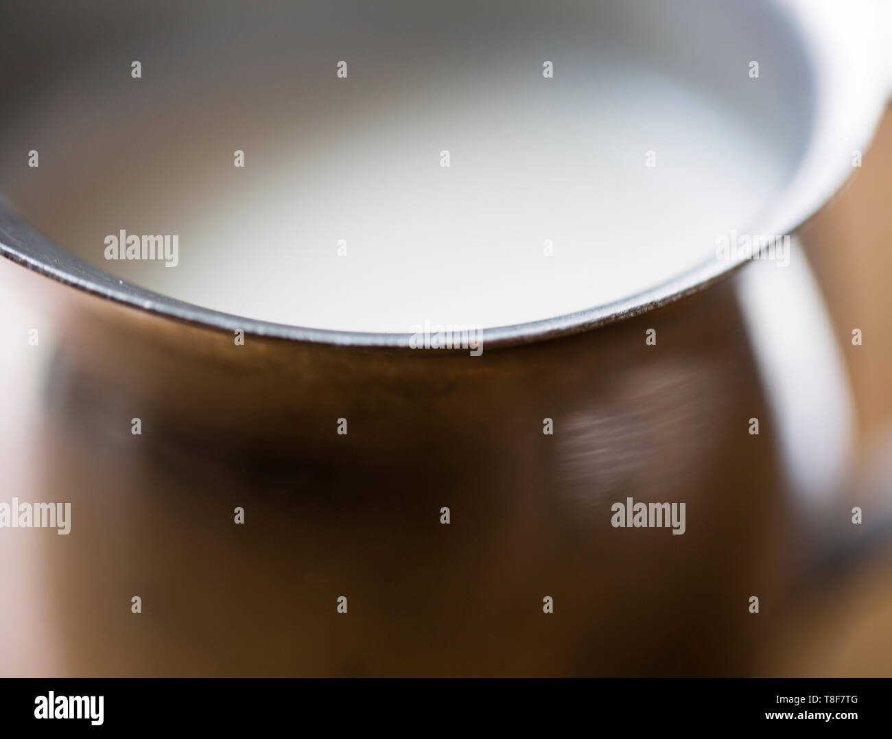 Milk in a silver creamer Stock Photo Alamy