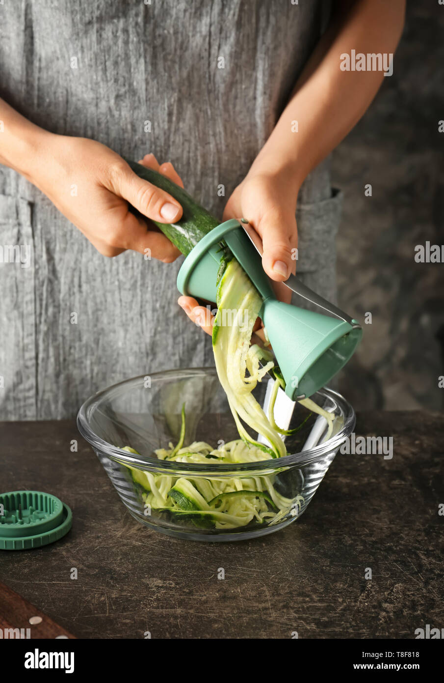 Woman making zucchini spaghetti, closeup Stock Photo