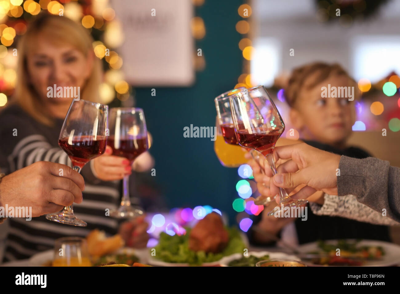 Happy family drinking wine during Christmas dinner at home Stock Photo ...