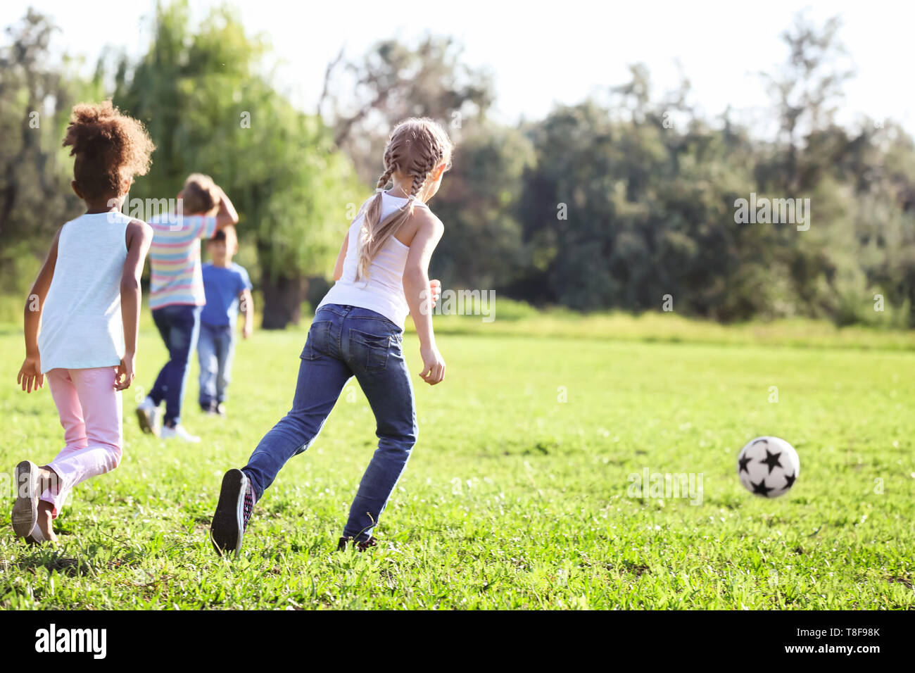 Cute little children playing football outdoors Stock Photo - Alamy