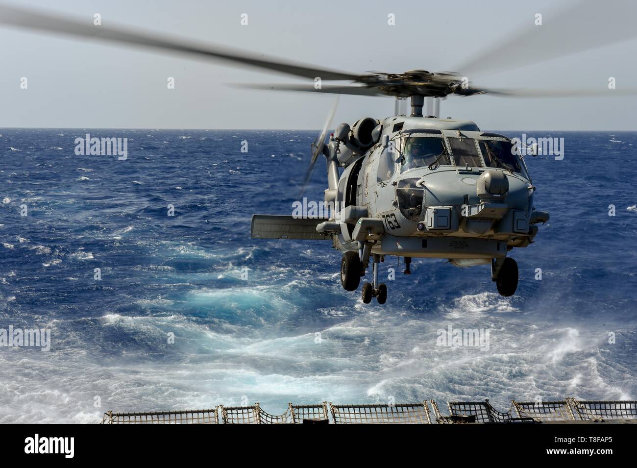 190509-N-UM706-0063 RED SEA (May 9, 2019) An MH-60R Sea Hawk Helicopter assigned to the “Grandmasters” of Helicopter Maritime Strike Squadron 46 aboard the Arleigh Burke-class guided-missile destroyer USS Nitze (DDG 94) takes off from the ship’s flight deck. Nitze is underway as part of Abraham Lincoln Carrier Strike Group (ABECSG), which is deployed to the U.S. Central Command area of responsibility in order to defend American forces and interests in the region. With Abraham Lincoln as the flagship, deployed strike group assets include staffs, ships and aircraft of Carrier Strike Group 12, De Stock Photo