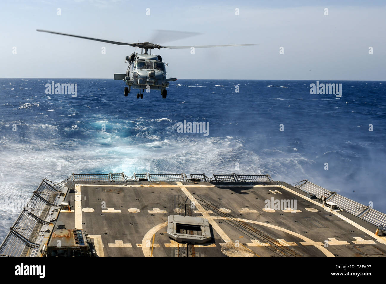 190509-N-UM706-0068 RED SEA (May 9, 2019) An MH-60R Sea Hawk Helicopter assigned to the “Grandmasters” of Helicopter Maritime Strike Squadron 46 aboard the Arleigh Burke-class guided-missile destroyer USS Nitze (DDG 94) takes off from the ship’s flight deck. Nitze is underway as part of Abraham Lincoln Carrier Strike Group (ABECSG), which is deployed to the U.S. Central Command area of responsibility in order to defend American forces and interests in the region. With Abraham Lincoln as the flagship, deployed strike group assets include staffs, ships and aircraft of Carrier Strike Group 12, De Stock Photo